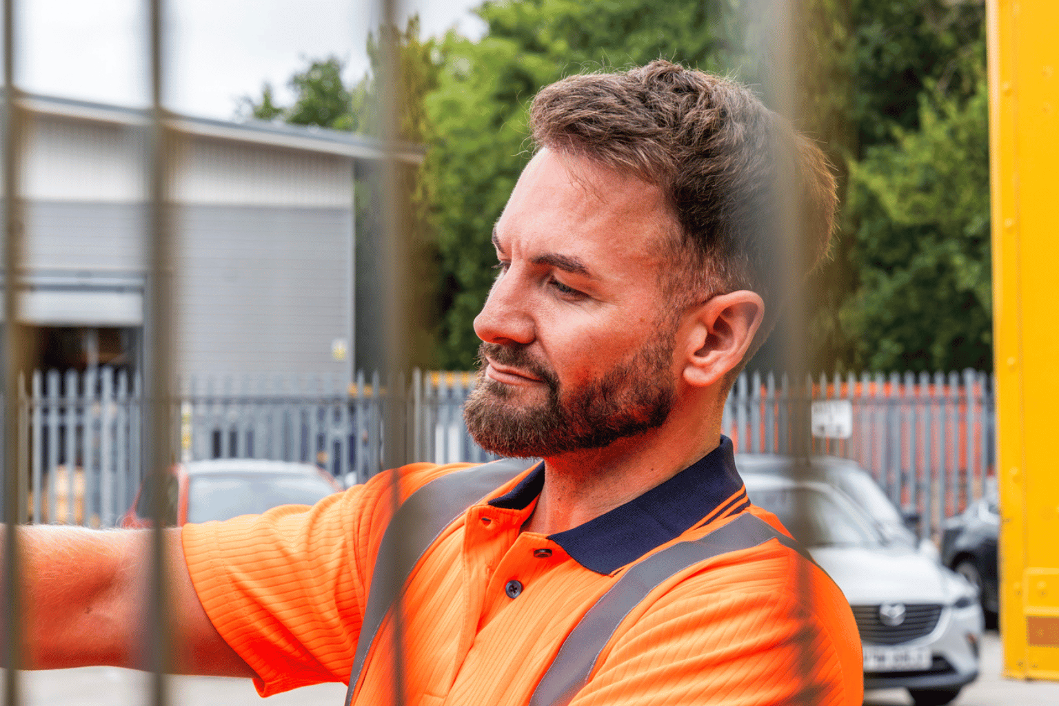 Worker in an orange hi-vis t-shirt.