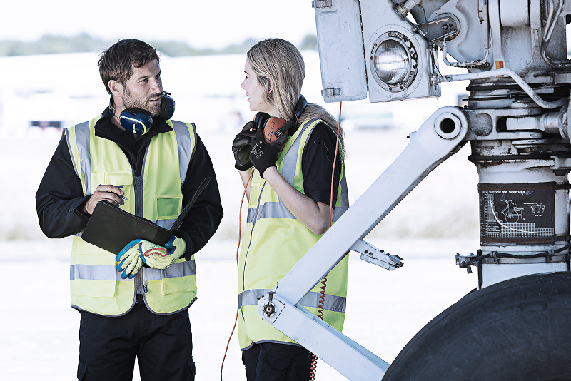 Airport employees wearing uniforms.