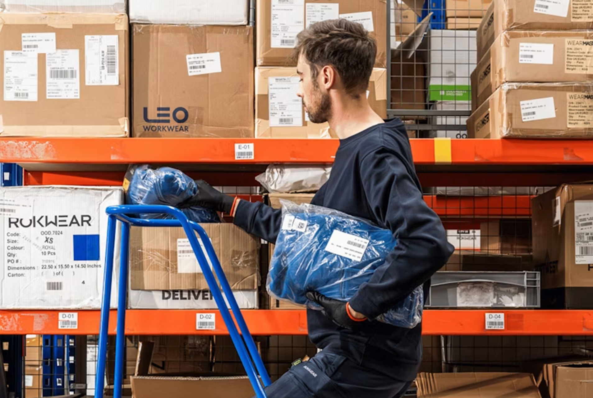 A man on a warehouse ladder.