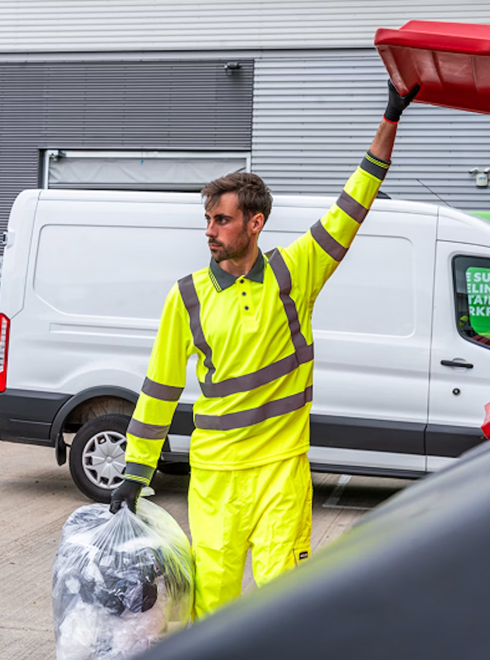 A man opening a bin wearing uniform.