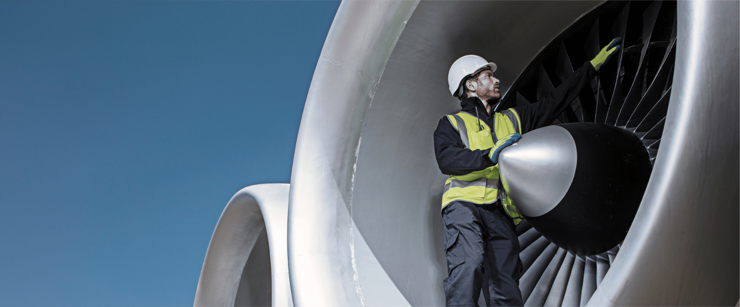 Man in hi-vis working on an airplane.