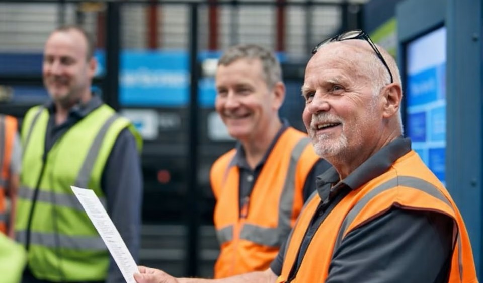 Man in orange hi-vis PPE.