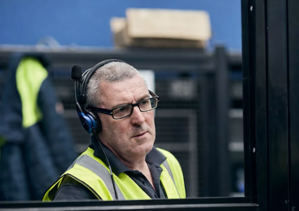 Man in yellow hi-vis PPE.
