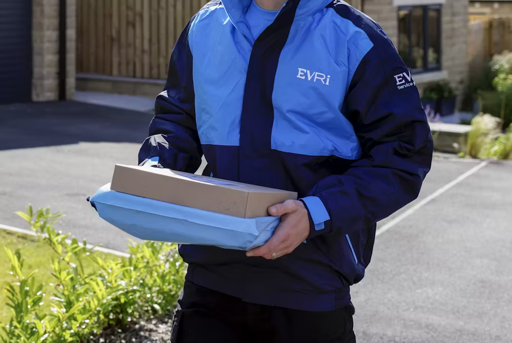Evri employee carrying a parcel.