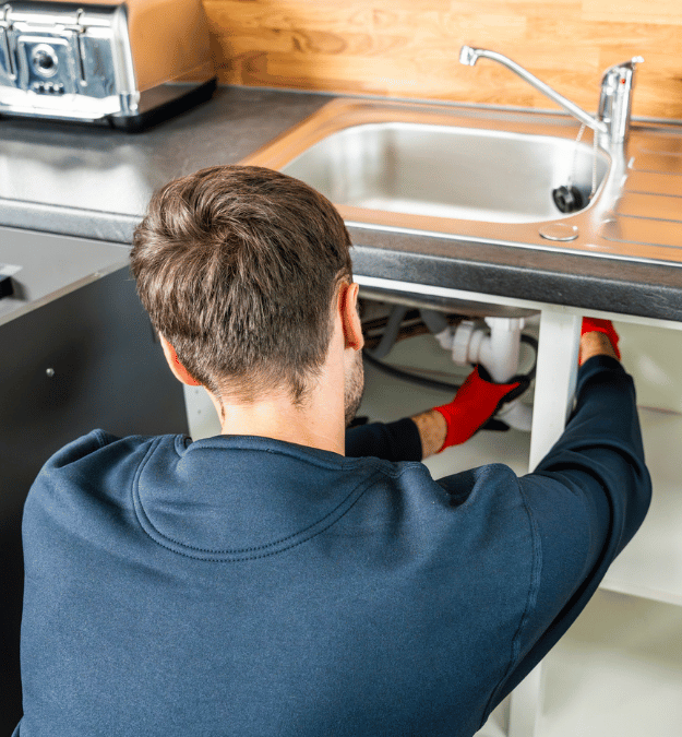 Worker fixing a sink wearing ROKWEAR® Gloves.